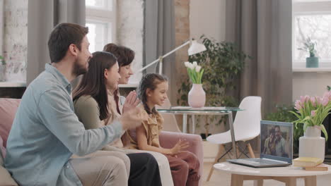 family enjoying a video call together in their living room