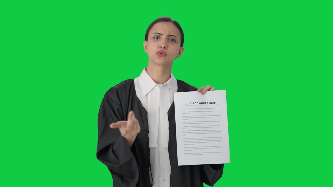 Serious Indian female lawyer explaining the document Green screen