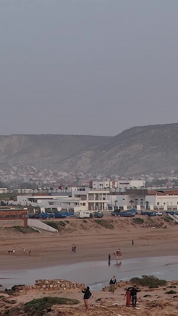 Vista aérea de una zona de playa en Marruecos con olas y gente caminando