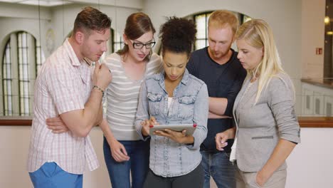 colleagues looking at ideas on tablet