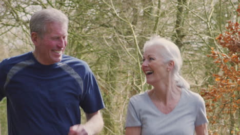 senior couple running in countryside exercising during covid 19 lockdown