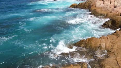 beach paradise cabo mexico ocean beach pans up from rocks to reveal ships on the horizon