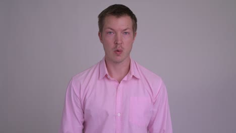 Young handsome businessman with pink shirt