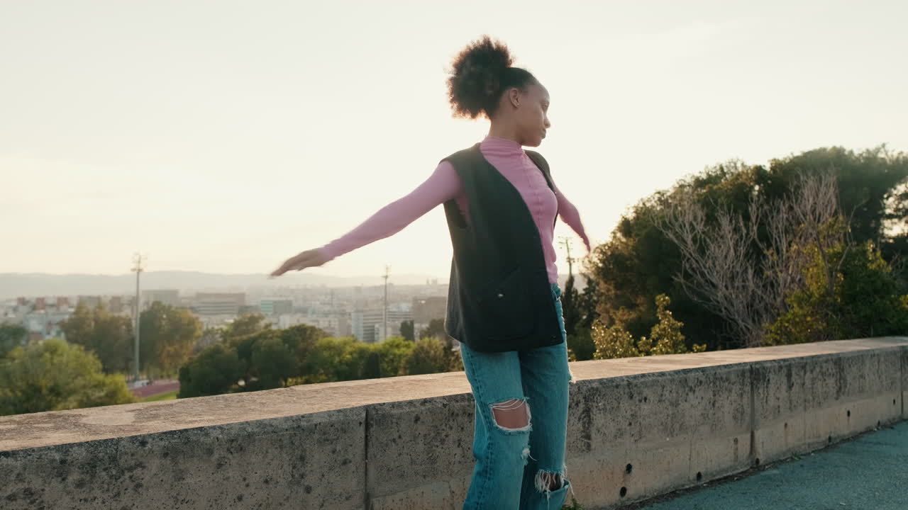 Young Girl Dancing in the City at Sunset