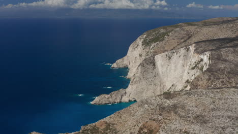 dramatic cliffs and azure waters of a greek island