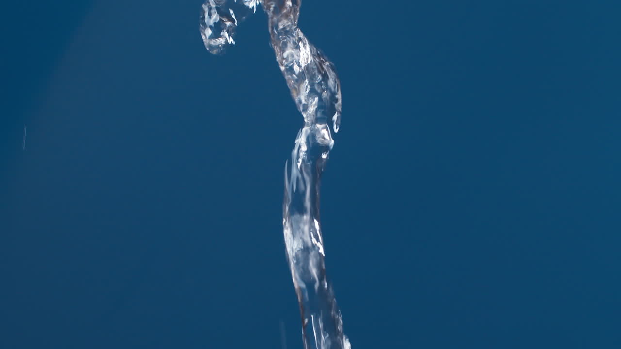 슬로우 모션으로 촬영하는 파란색 배경에 물이 튀면서 흐르는 진짜 순수한 물