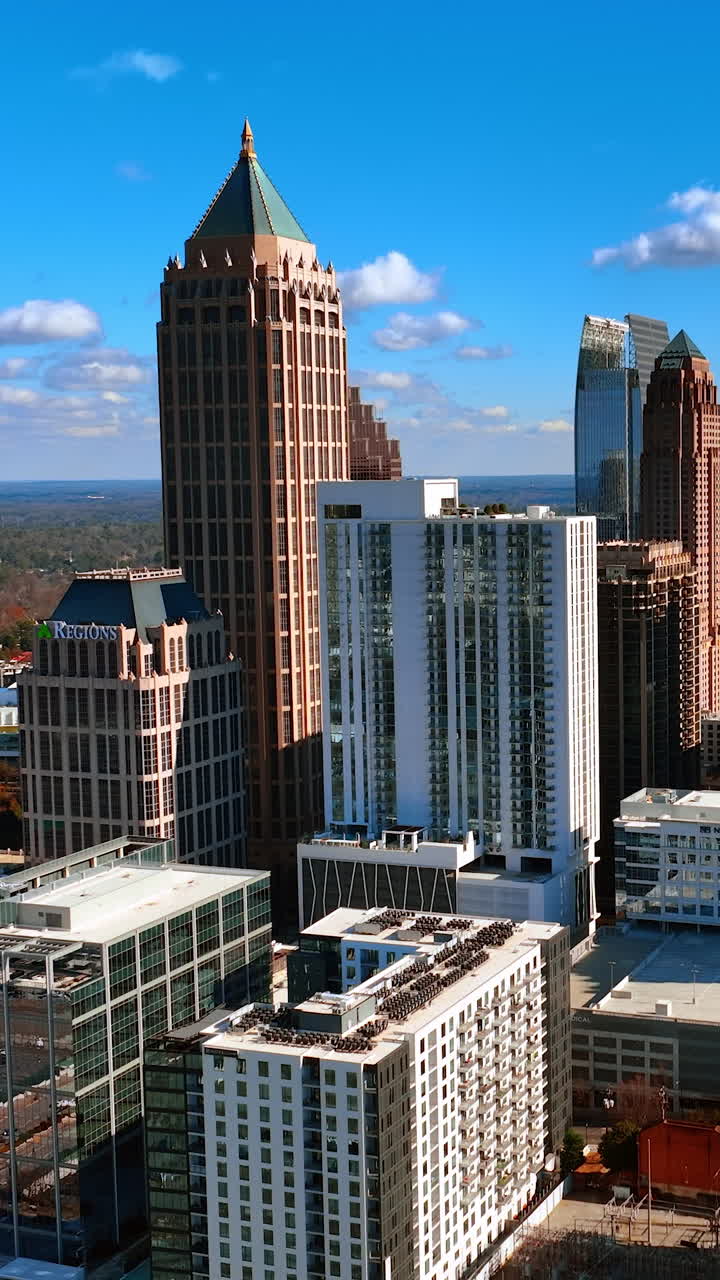 Beautiful modern buildings in the downtown of Atlanta. Panorama of the city on sunny day from air. Vertical video
