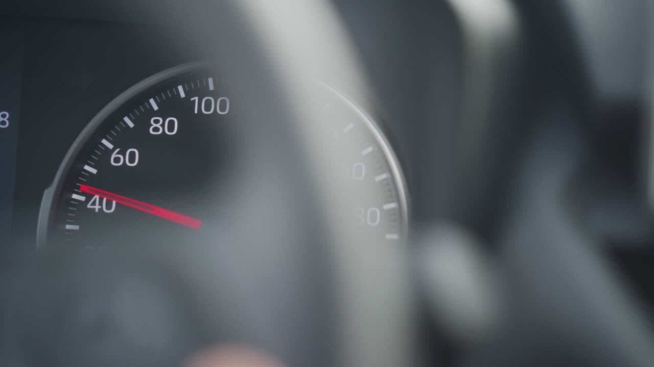 Car tachometer and moving pointer, car dashboard panel detail closeup