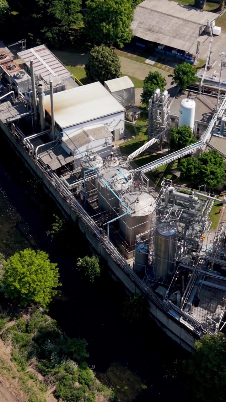 Aerial footage of a chemical production facility in Italy. Large industrial infrastructure with storage tanks and transport connections. Logistics and manufacturing concept in Europe.