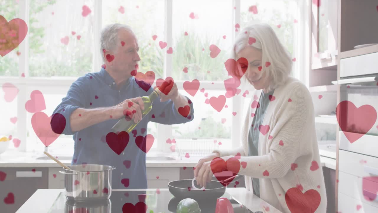 animación de los corazones sobre la cocina de una feliz pareja caucásica de alto nivel