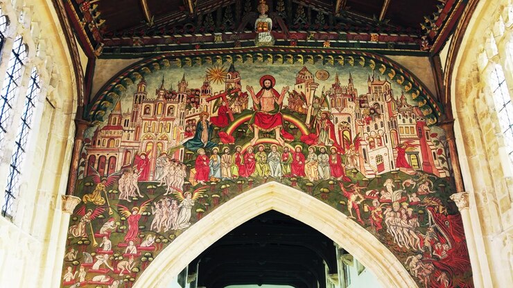 Wide interior view of the medieval Doom Painting above the chancel arch inside historic St Thomas Church in Salisbury Wiltshire