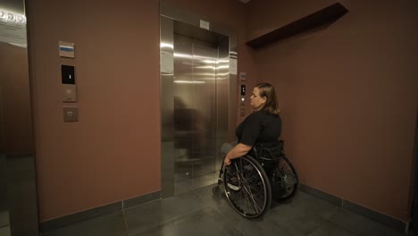 a woman in a wheelchair approaches an elevator in a hotel lobby, showcasing accessible accommodations and modern design. the scene emphasizes mobility, independence, and inclusivity in hospitality.