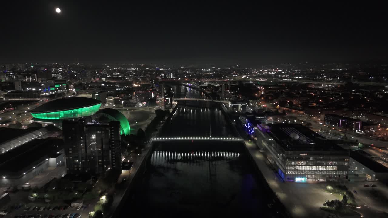 Modern famous city skyline, moonlight illuminated, aerial dolly scenery