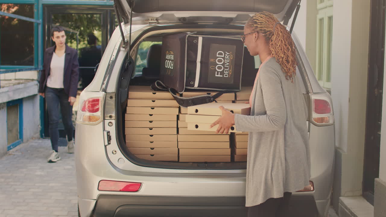 Pizza delivery with car trunk full of pizza boxes