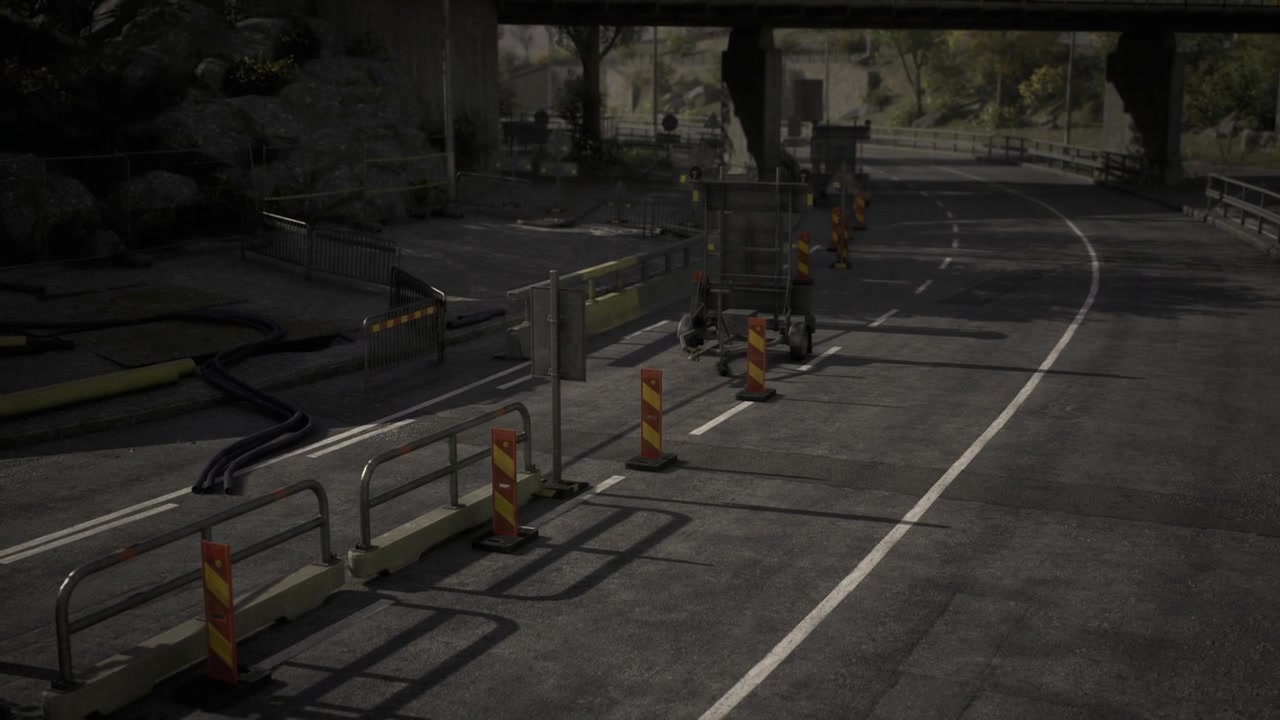 Quiet road under bridge with construction signs and barriers