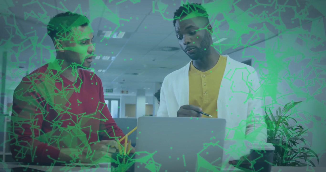 Coworkers pointing at laptop activating network overlay for business review and reviewing documents