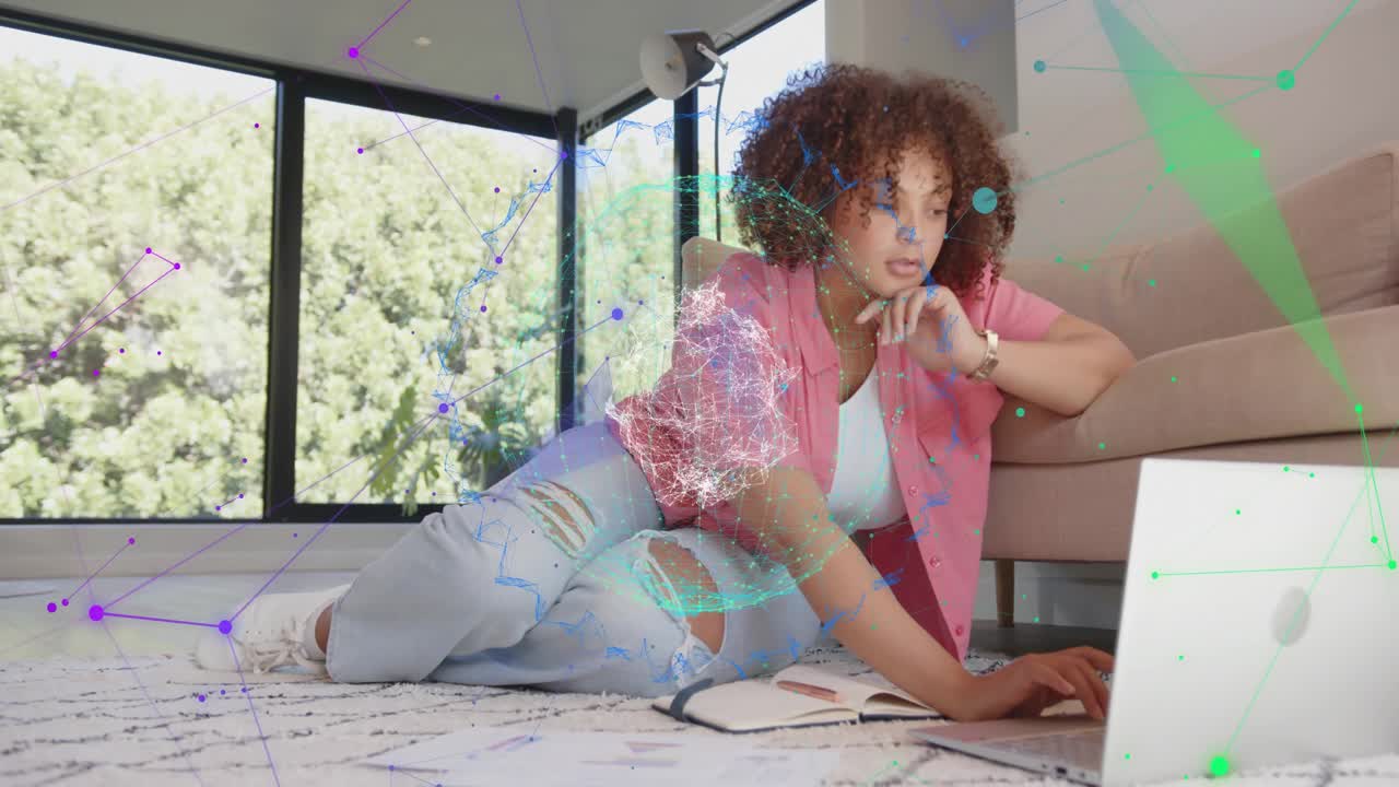 Woman lifting document then typing on laptop, researching business report with colorful overlays