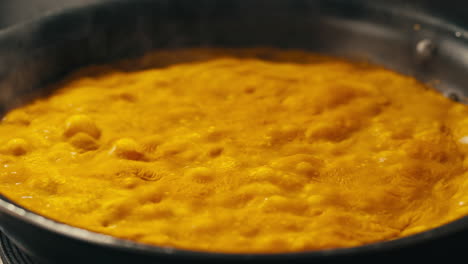 yellow boiling sauce on pan close-up. asian cuisine concept. curry is a dish with a sauce seasoned with spices. curries may contain fish, meat, poultry, or shellfish, either alone or in combination with vegetables. others are vegetarian.