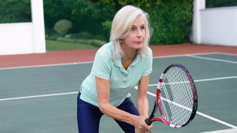 senior woman playing tennis in tennis court 4k