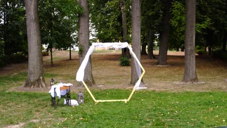 hexagonal wedding altar and benches before ceremony, backward dolly