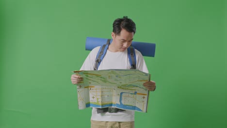 man looking at map with backpack