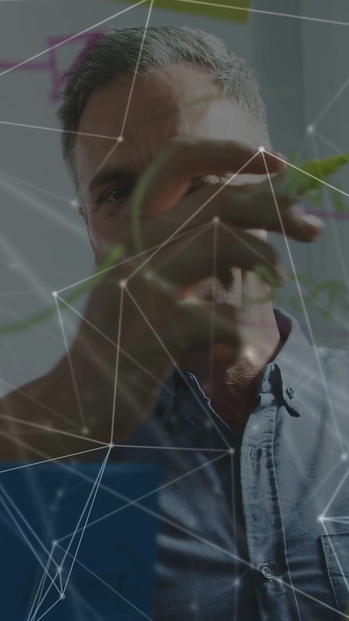 Vertical video: Leader scanning board placing notes drawing links overlay forming showing key idea
