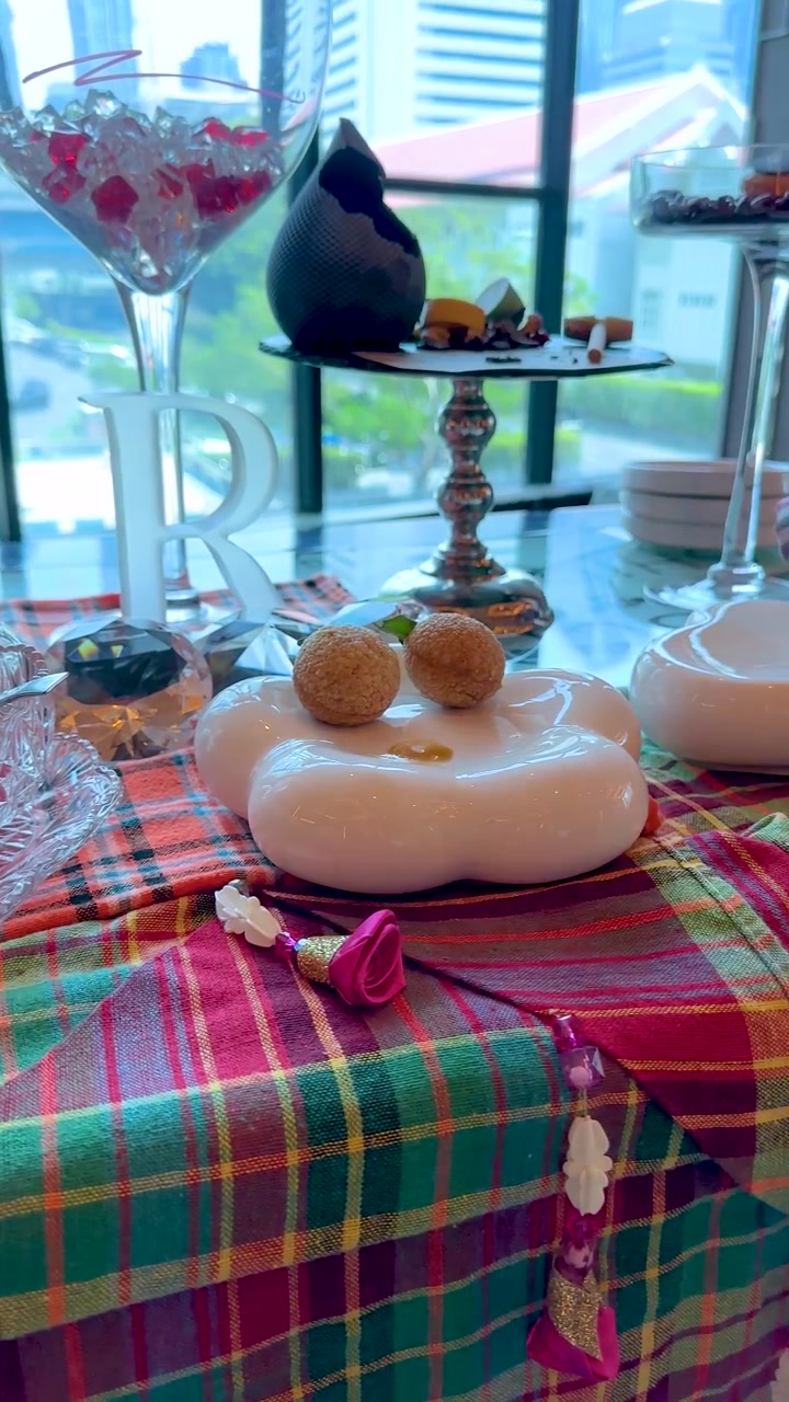 A slow panning shot across a luxury hotel table set with elegant Thai desserts