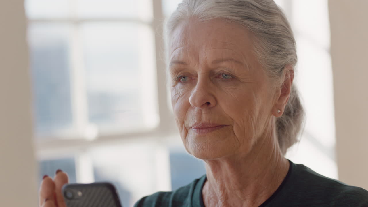 primo piano ritratto bella vecchia donna che utilizza smartphone durante una lezione di yoga condividendo uno stile di vita sano sui social media godendosi la navigazione in pratiche di meditazione online in palestra