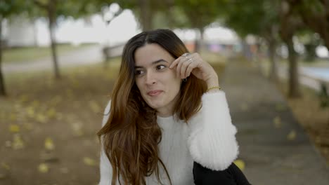 young woman sitting in a park