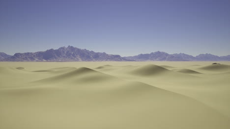 desert landscape with rolling sand dunes and mountains under clear sky