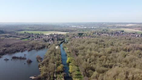 Drone-flies-backwards-above-the-forest-near-the-small-village-Fordwich,-England