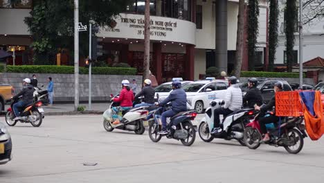 motorbikes and cars navigating city traffic