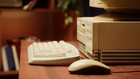 person inserting floppy disk into a vintage computer