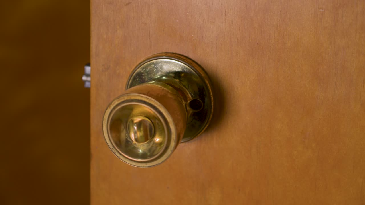 A vintage door knob with a turn lock