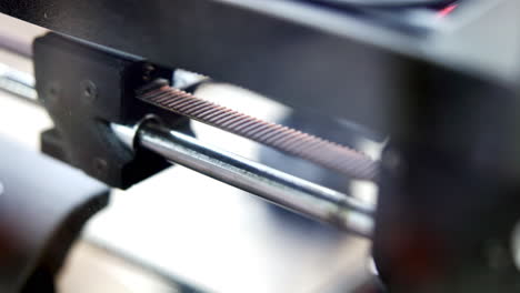 close-up of a machine's belt and rod mechanism