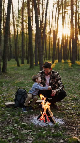 father and son roasting marshmallows by a campfire in the forest