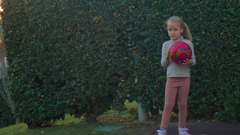 Niño-Jugando-Con-Pelota-En-El-Frondoso-Patio-Trasero