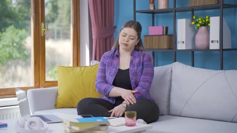 Unwell-young-woman-watches-out-the-window-to-relax.