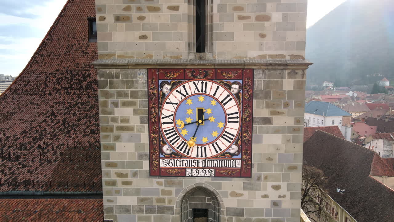 Vista aérea por drone da Igreja Negra no centro antigo de Brasov, Romênia. Close da torre do sino, edifícios residenciais antigos ao redor. Tradução do texto: A Palavra do Senhor Permanece para Sempre