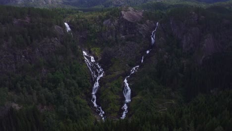 lush, green norwegian landscape with cascading waterfalls and rocky terrain