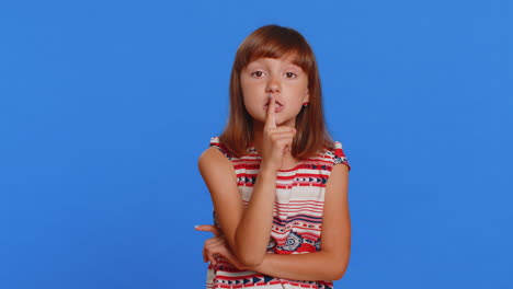 preteen child girl presses finger to lips makes silence hush sign do not tells gossip secret quiet
