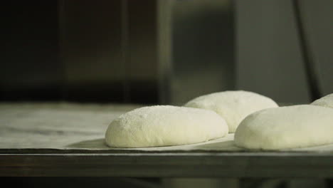 Dough-Of-Sourdough-Bread-Proofing-On-The-Baking-Tray-At-The-Kitchen-Of-Bakery