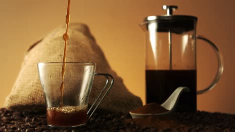 coffee pouring into a glass cup