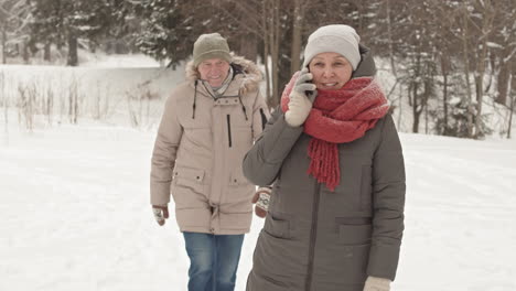 senior couple walking in snowy park