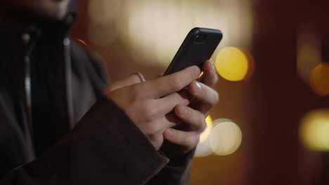 Man-hands-texting-on-phone-on-street.-Unrecognizable-guy-writing-message-phone.