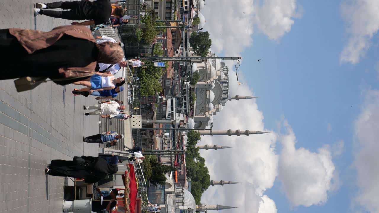 Bustling street scene with a grand mosque under a cloudy sky