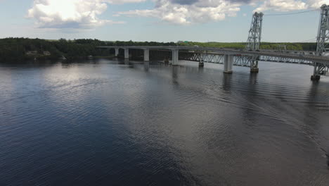 Reverse-Drone-shot-revealing-small-cruise-ship-on-the-Kennebec-River