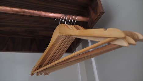 close-up of wooden coat hangers on a rail