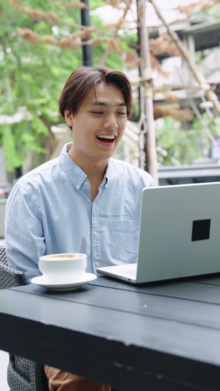 Man working on laptop at cafe