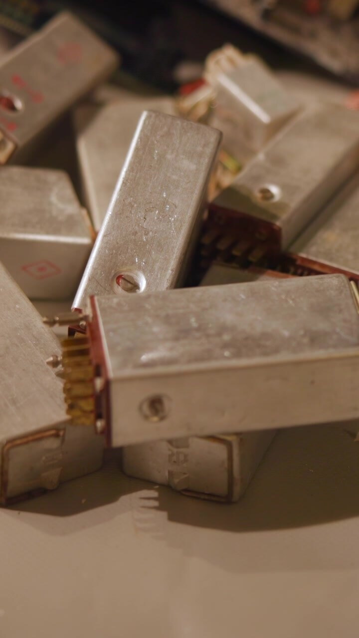 Top down motion scene of chocolate bars stacking and rearranging on light colored surface, forming neat layered display against neutral background with clean commercial styling, soft light, and calm